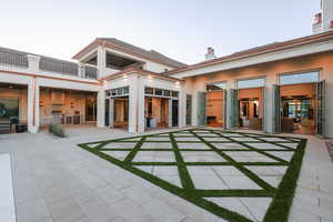 Rear view of house with exterior kitchen and a patio area