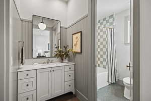 Full bathroom with shower / tub combo, vanity, tile patterned flooring, and toilet