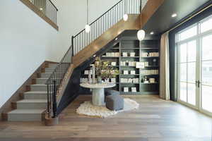 Wine room featuring french doors, hardwood / wood-style floors, and a wealth of natural light