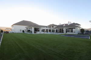 Rear view of property featuring a yard and a gazebo