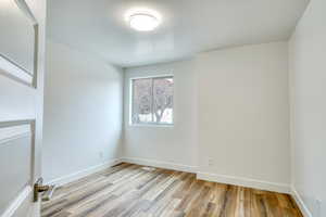 Unfurnished room with light hardwood / wood-style flooring