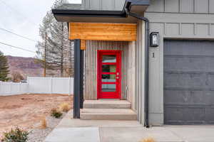 View of exterior entry featuring a garage and a mountain view