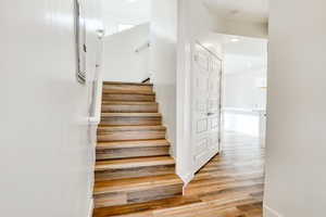 Stairway with hardwood / wood-style floors and sink