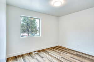 Unfurnished room with light hardwood / wood-style floors