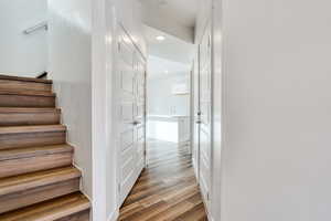 Staircase featuring hardwood / wood-style flooring