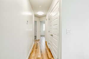 Corridor featuring light wood-type flooring