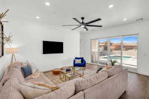 Living room with wood-type flooring and ceiling fan