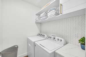 Washroom with washer and clothes dryer