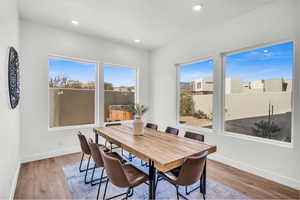 Dining space with light hardwood / wood-style flooring