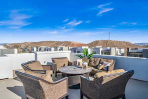 View of patio with a balcony and a mountain view