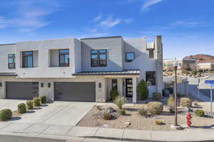 View of front of property with central AC unit and a garage