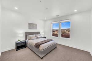 Bedroom featuring light colored carpet