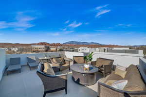 View of patio with a mountain view and outdoor lounge area