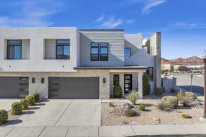 Contemporary home featuring a garage and a mountain view