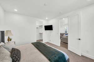 Carpeted bedroom featuring a spacious closet