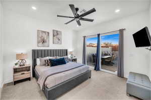 Carpeted bedroom featuring access to outside and ceiling fan