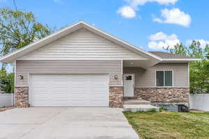 View of front of home featuring a garage and a front yard