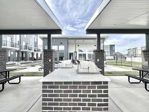 View of patio featuring exterior kitchen and an outdoor bar