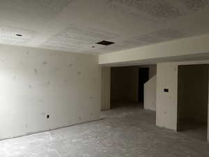 Unfurnished room featuring a textured ceiling