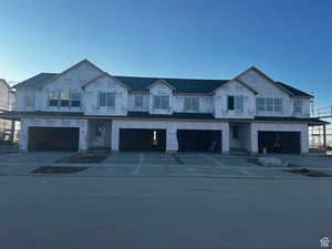 Unfinished property featuring a garage