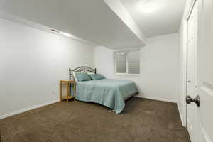 Bedroom featuring dark colored carpet