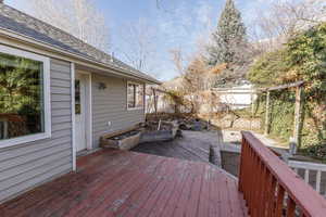 Wooden deck featuring an outdoor fire pit