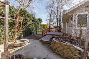 View of patio / terrace with a deck and a fire pit