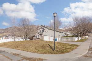 View of front of house featuring a garage and a front lawn