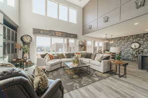 Living room with a chandelier and light wood-type flooring