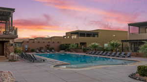 Pool at dusk featuring a patio area