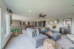 Carpeted living room featuring a healthy amount of sunlight