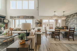 Interior space with hardwood / wood-style flooring, plenty of natural light, and a notable chandelier