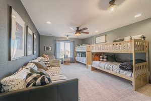 Carpeted bedroom with ceiling fan