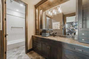 Bathroom with vanity and tiled shower / bath