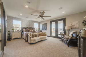 Carpeted bedroom featuring multiple windows, access to outside, ceiling fan, and french doors