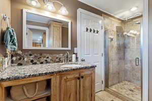 Bathroom featuring vanity and an enclosed shower