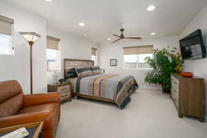 Carpeted bedroom with ceiling fan