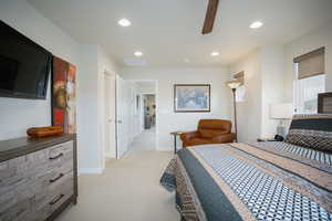 Bedroom featuring ceiling fan and light carpet