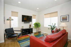 Living room with hardwood / wood-style flooring