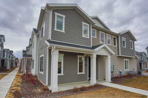 View of front of home with cooling unit