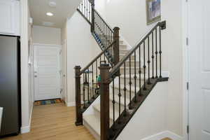 Staircase featuring wood-type flooring