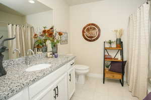 Bathroom with tile patterned floors, vanity, and toilet