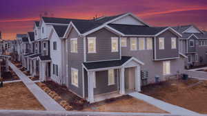 View of front of home featuring a garage and central AC