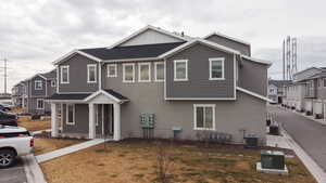 View of front of home featuring central AC and a front lawn