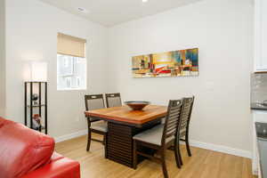 Dining room with light hardwood / wood-style floors