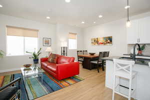 Living room with light hardwood / wood-style floors