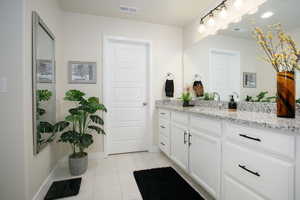 Bathroom with tile patterned flooring and vanity