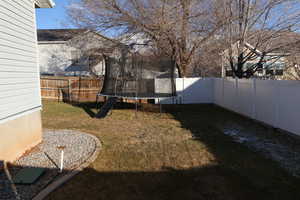 View of yard featuring a trampoline