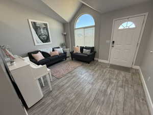 Foyer featuring vaulted ceiling and light hardwood / wood-style floors