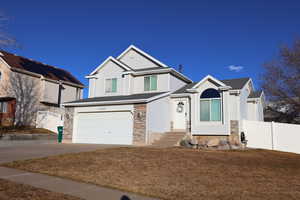 Craftsman-style house featuring a garage and a front lawn